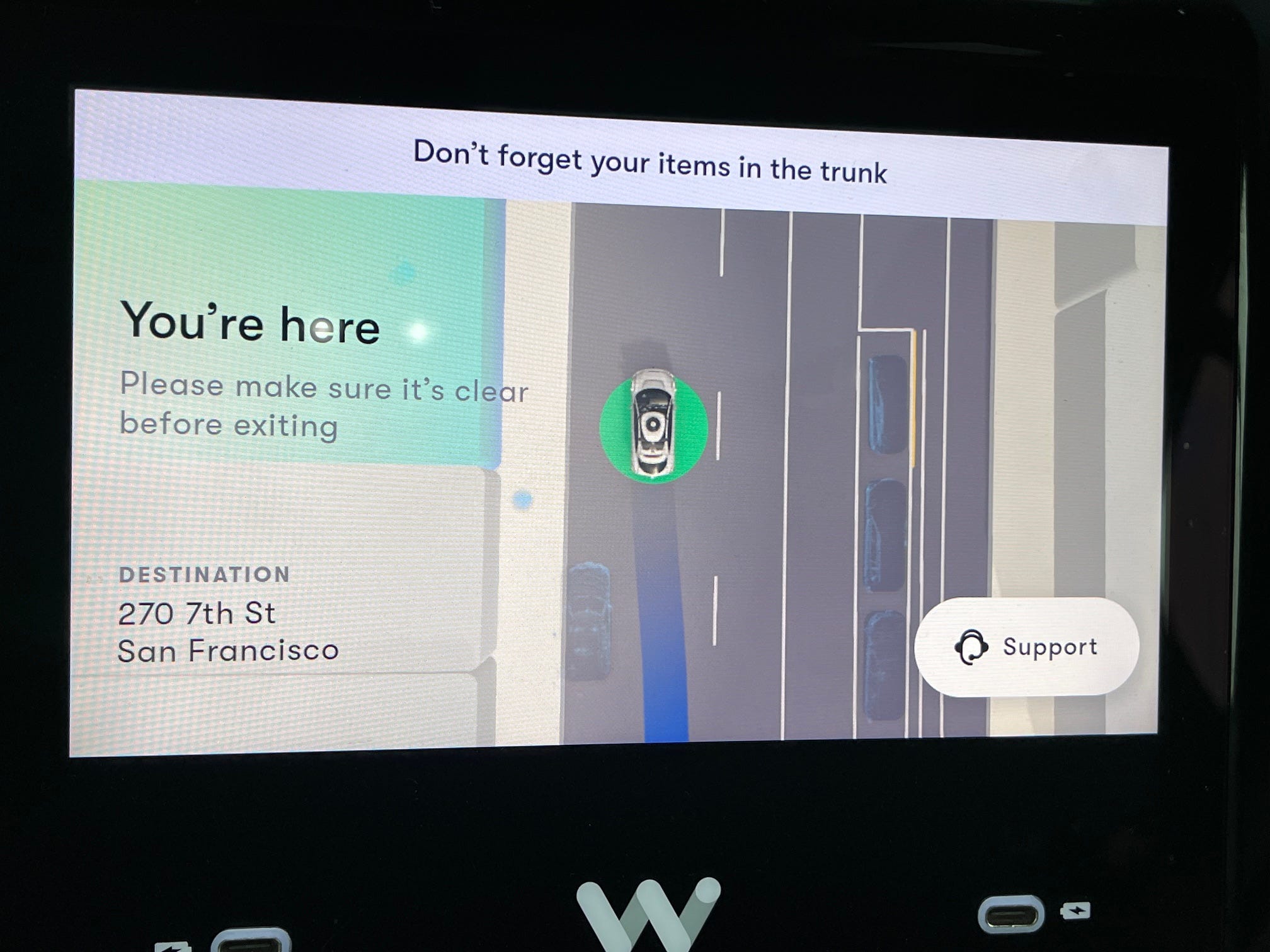 A message on the screen of a Waymo vehicle indicates that the car has arrived at its destination.