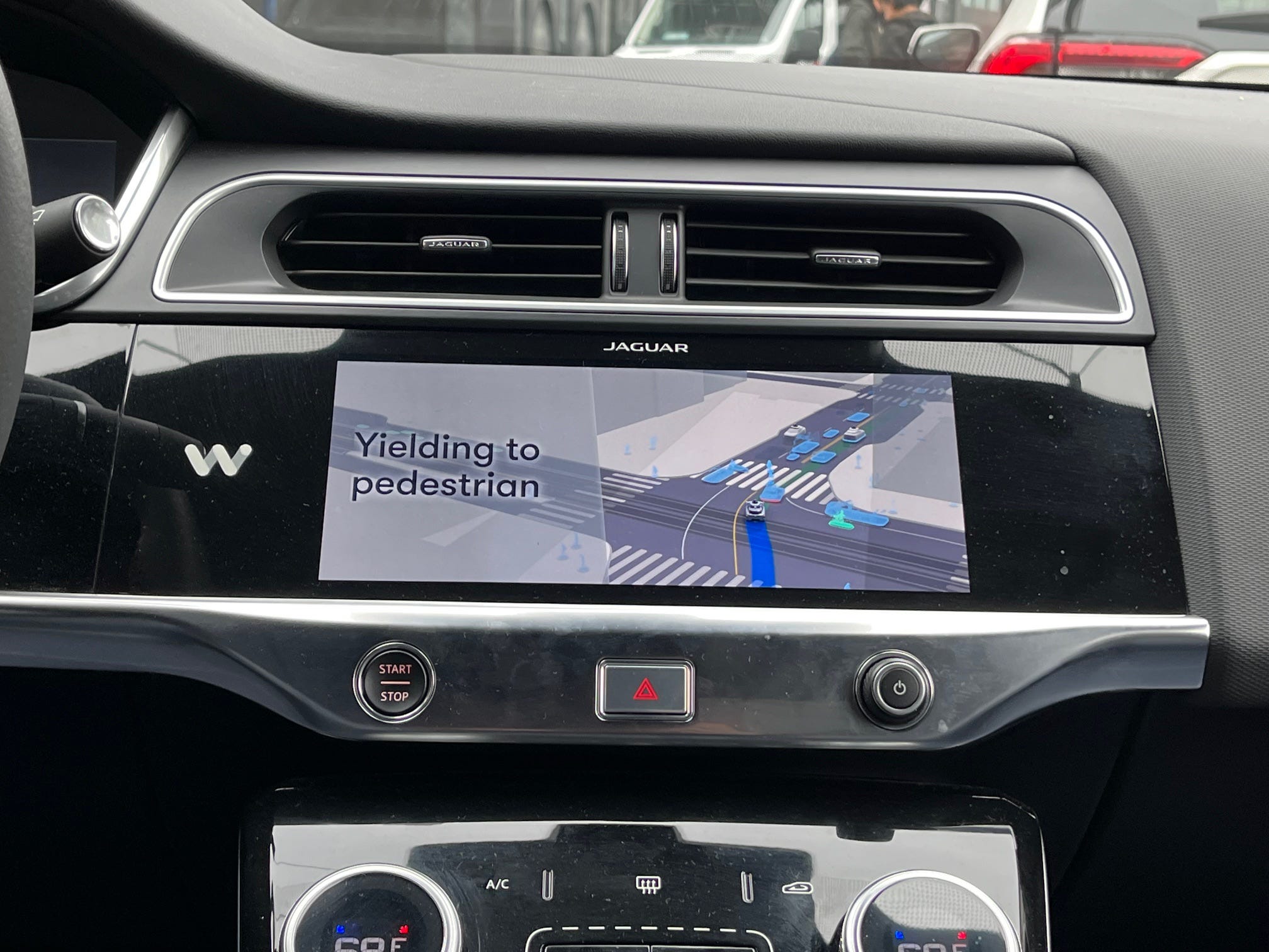 The screen in a Waymo vehicle informs riders that the car is stopped because it is 