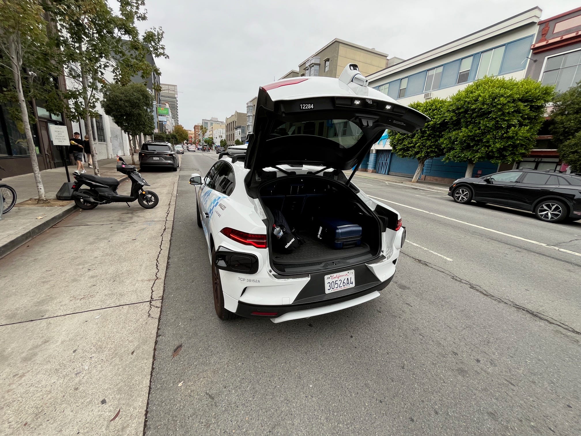 The back of a Waymo vehicle stands open.
