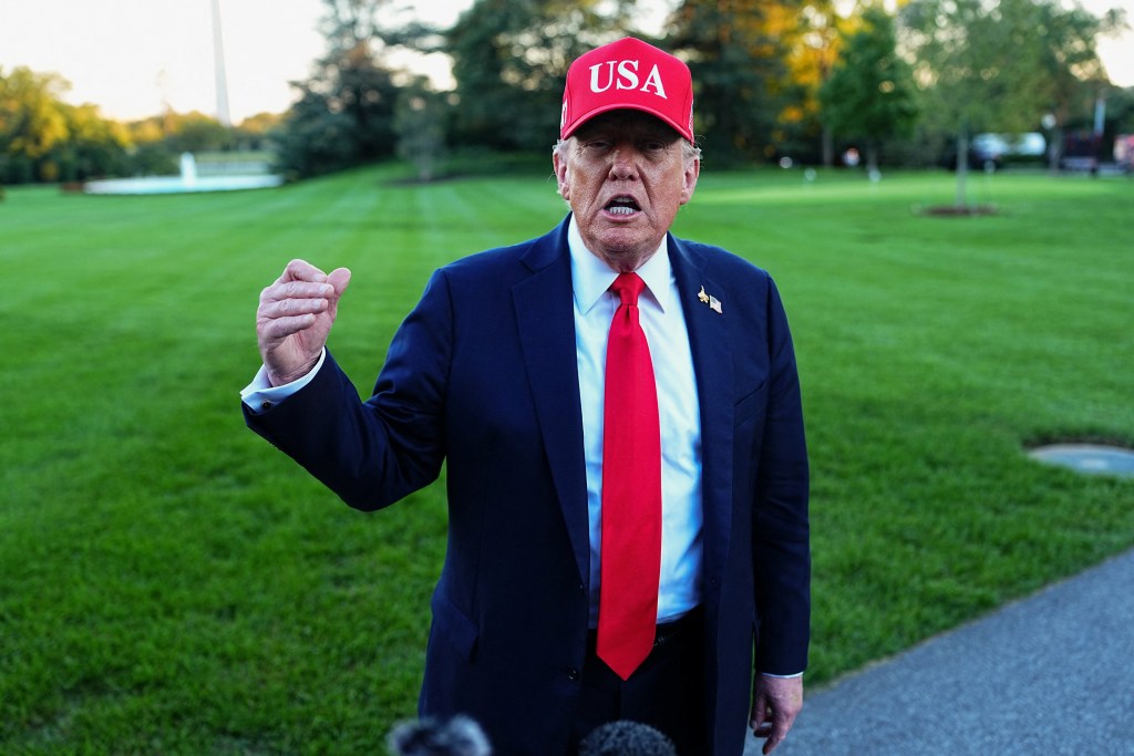 President Donald Trump speaks to members of the media as he arrives at the White House in Washington, D.C., U.S., October 5, 2025.
