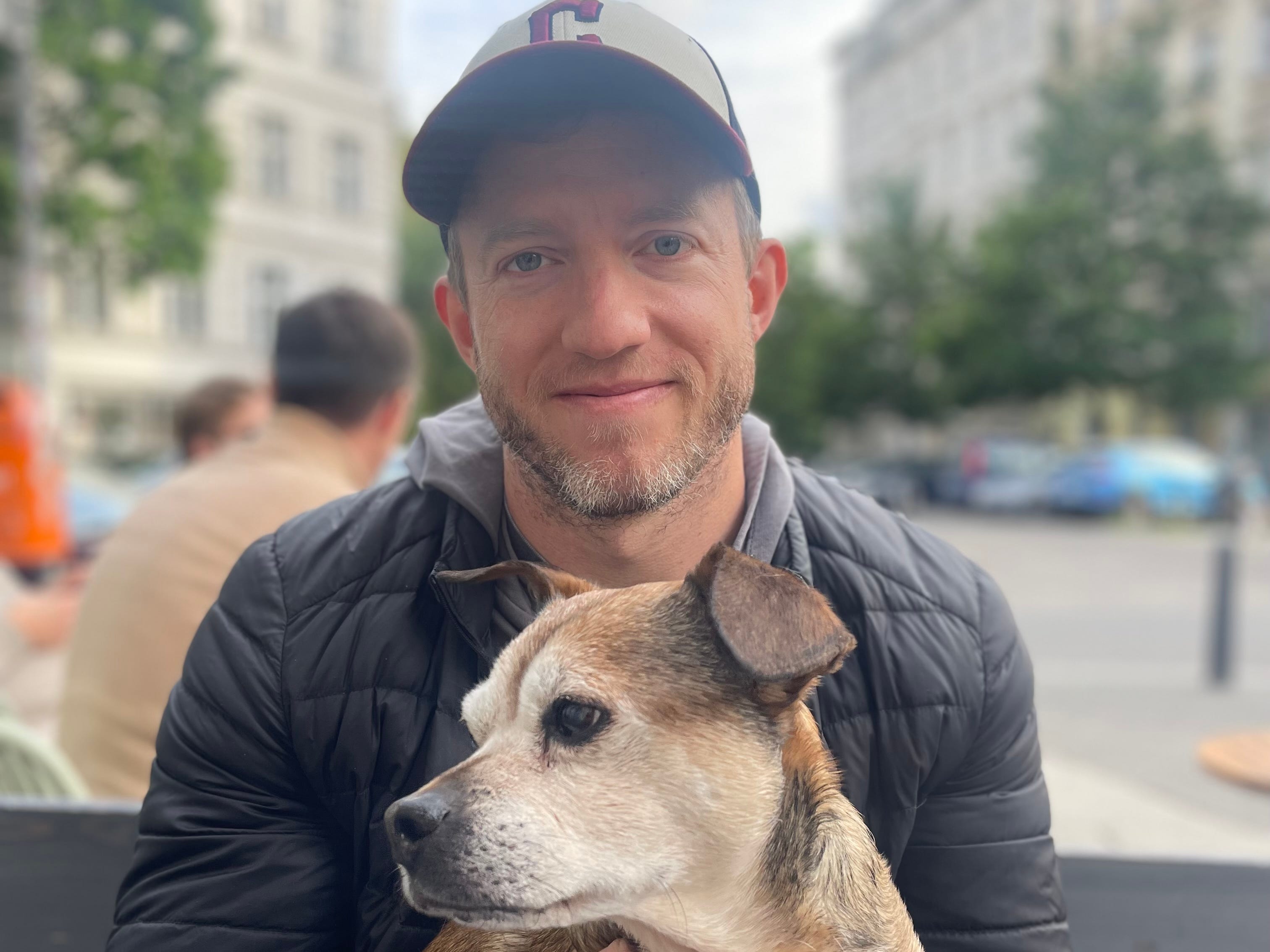 Author Joe Baur smiling with a dog