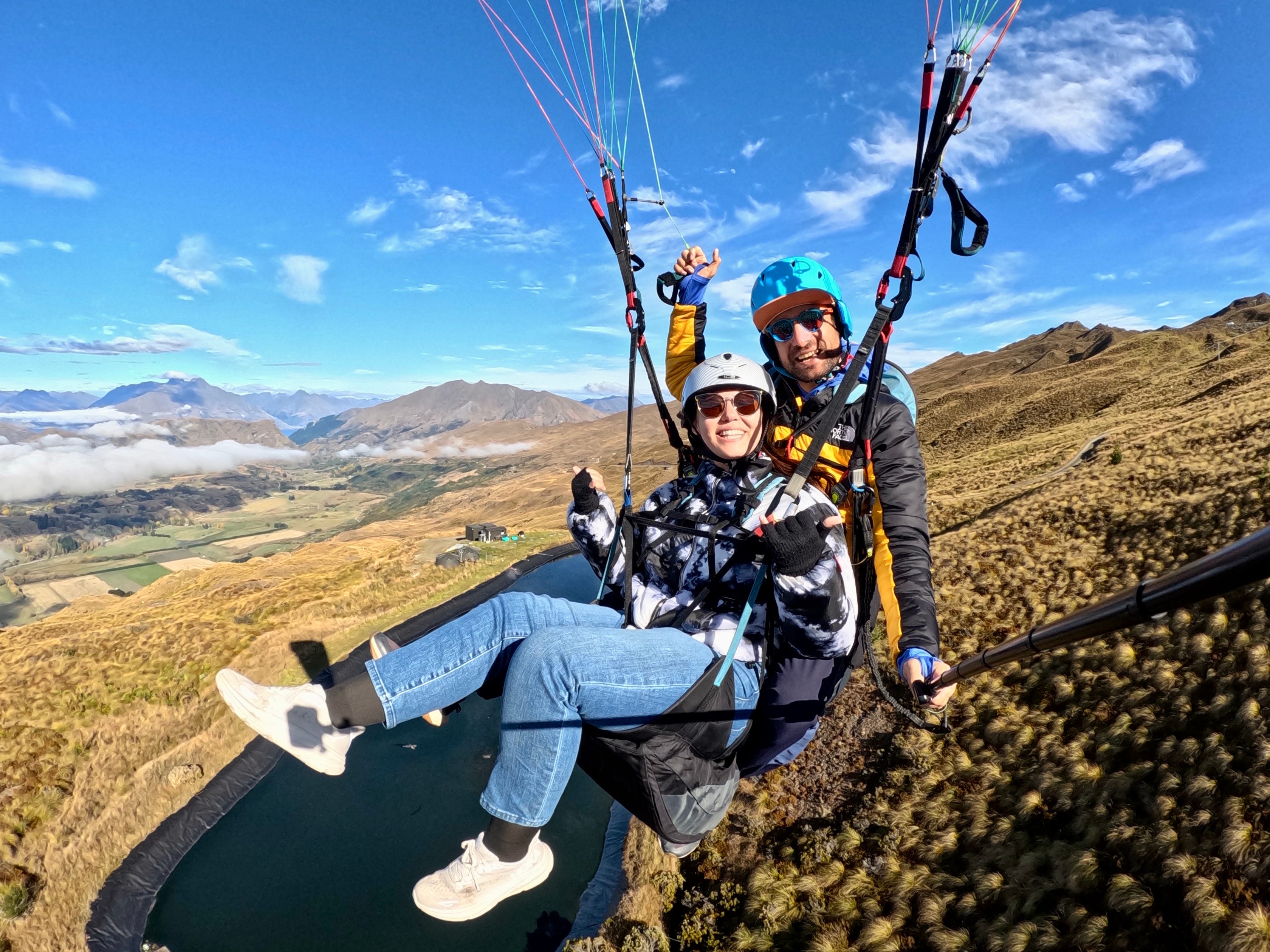 Author Ashley Probst paragliding with person attached to her