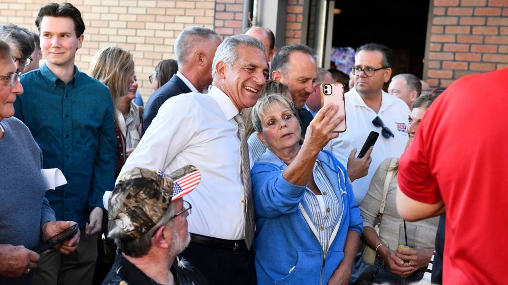 Jack Ciattarelli posing for a selfie with a supporter.