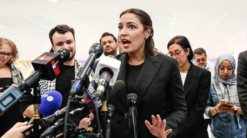 US Representative Alexandria Ocasio-Cortez, Democrat of New York,  speaks to the press next to former Columbia University student Mahmoud Khalil as he is greeted by family and friends upon arrival at Newark airport in Newark, New Jersey, on June 21, 2025. Mahmoud Khalil, a former Columbia University student who was one of the most visible leaders of nationwide pro-Palestinian campus protests, was released on June 20 from a federal detention center. Khalil, a legal permanent resident in the United States who is married to a US citizen and has a US-born son, has been in custody since March facing potential deportation.