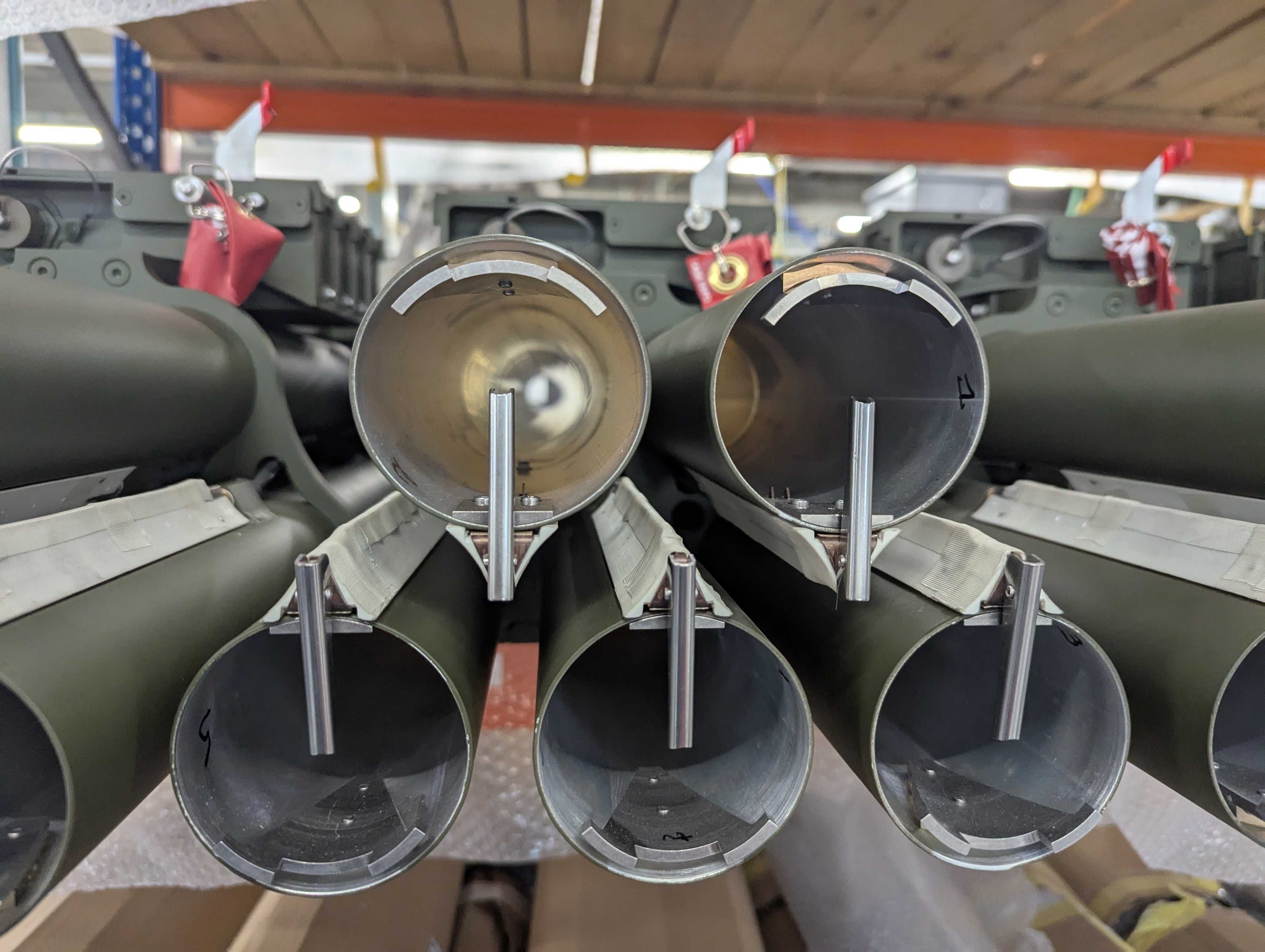 Rocket tubes can be seen in a workshop.