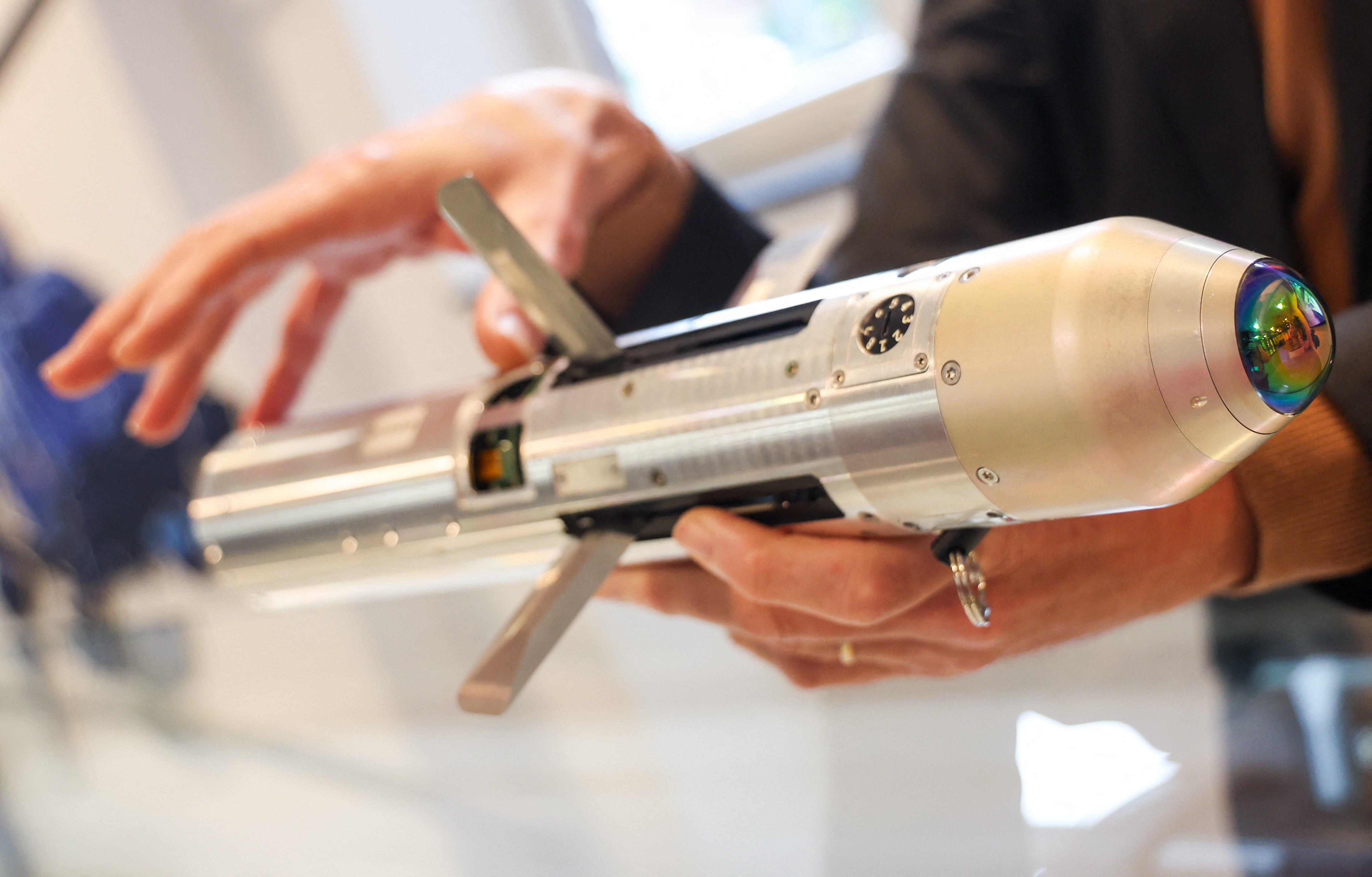 A Thales Belgium executive shows the FZ275 laser-guided rocket.