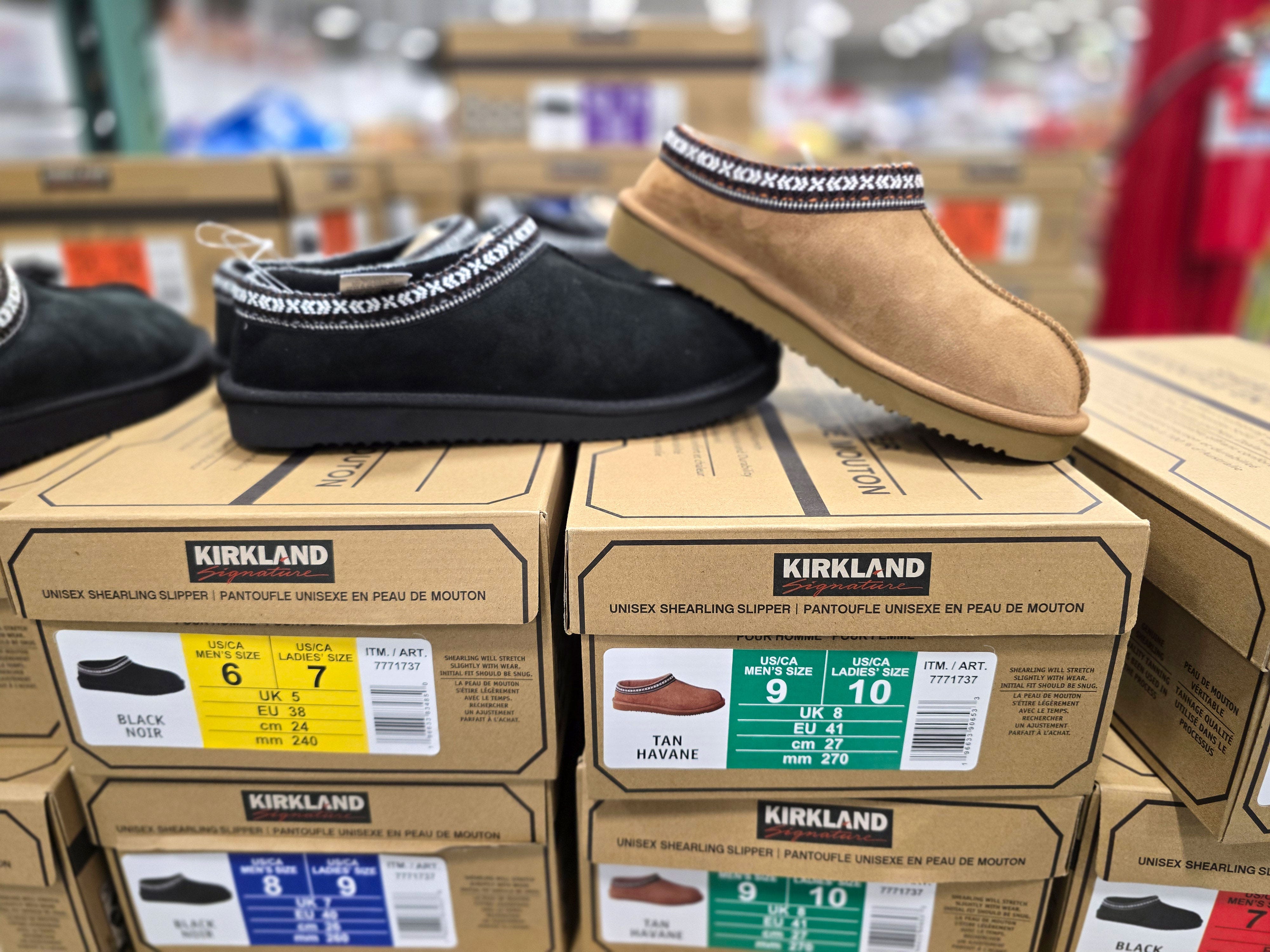 Slipper shoes in black and brown colorways on display at Costco.