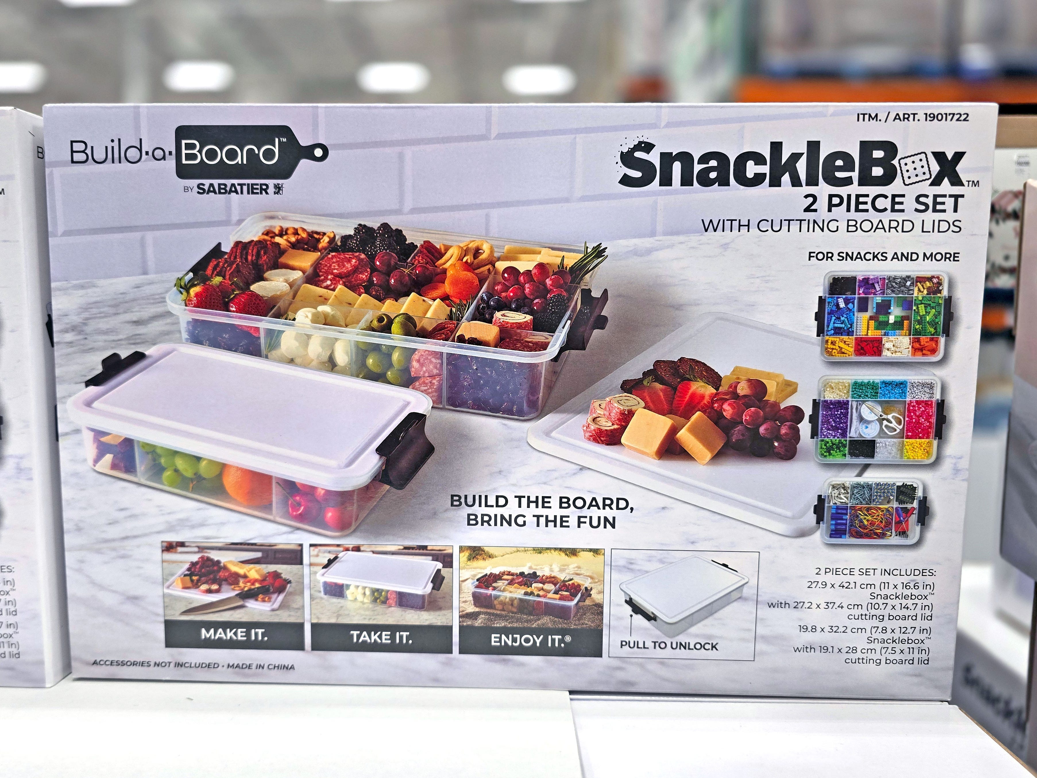 A Snackle Box set that includes two boxes with different compartments and two lids that look like cutting boards.