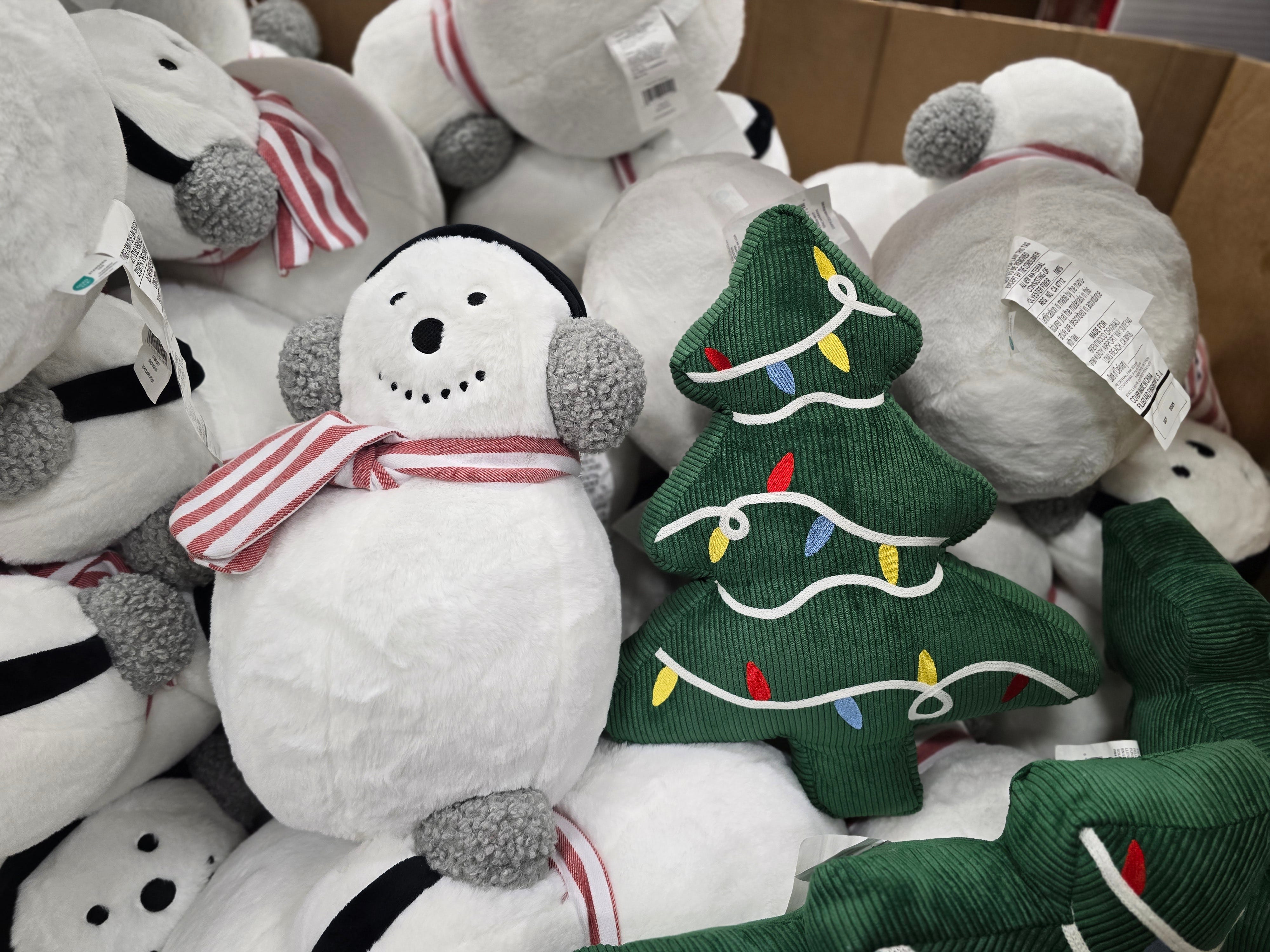 Snowman and Christmas tree pillows on display at Costco.