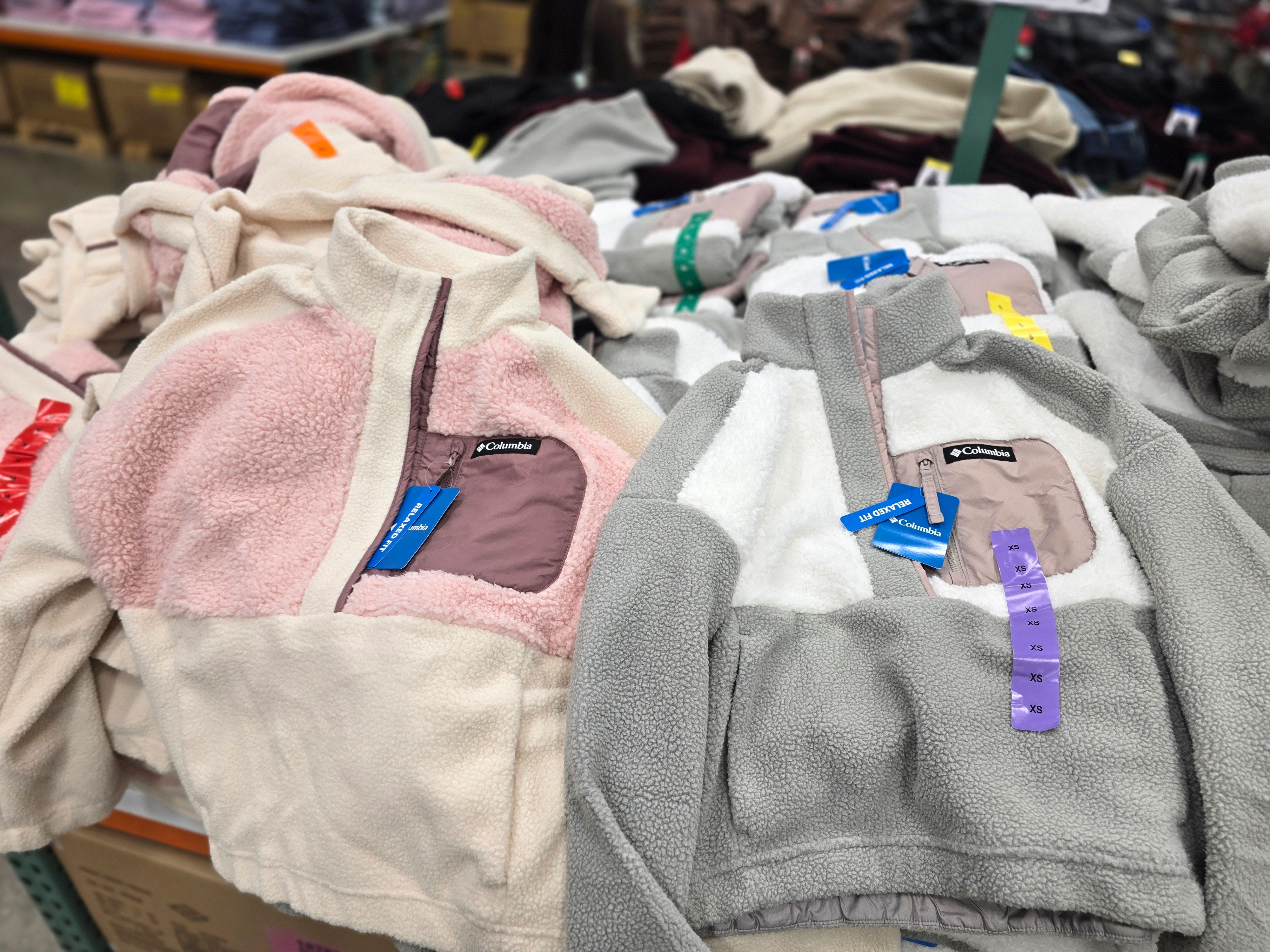Two color options of Columbia fleece pullover sweaters on display at Costco.