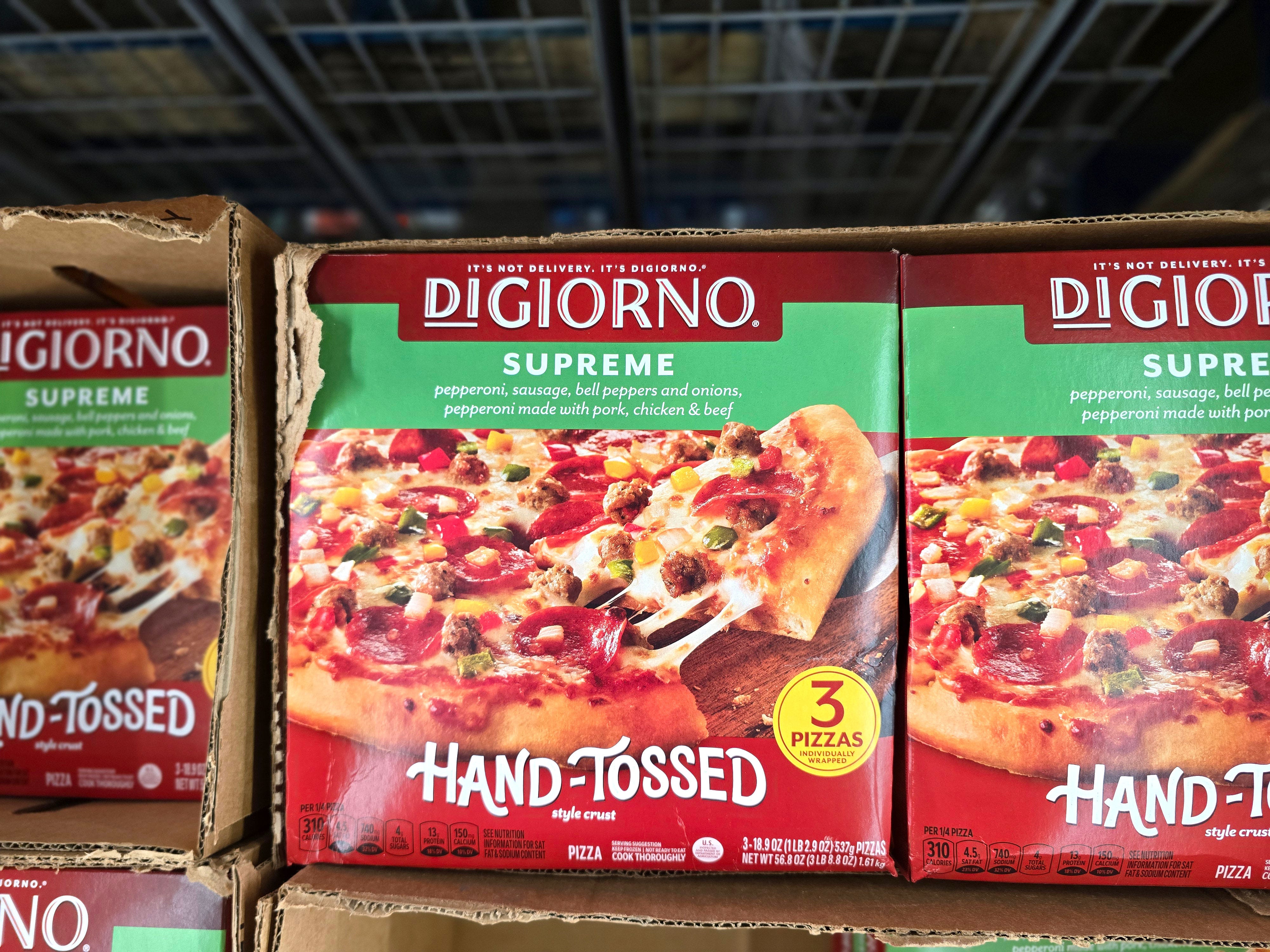 Boxes of DiGiorno frozen pizzas with lots of toppings.