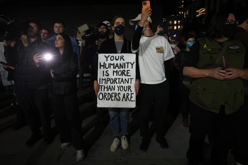 A protester holds a sign reading "Your Humanity Is More Important Than Your Orders Are" outside of a downtown U.S. Immigration and Customs Enforcement (ICE) facility on October 05, 2025 in Portland, Oregon.