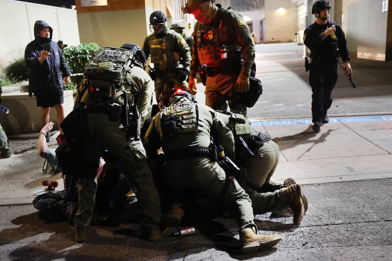 Federal agents, including members of the Department of Homeland Security, Border Patrol, and the police, arrest a protester outside a downtown U.S. Immigration and Customs Enforcement (ICE) facility on October 05, 2025 in Portland, Oregon where the facility has become a focal point of nightly protests against the Trump administration.