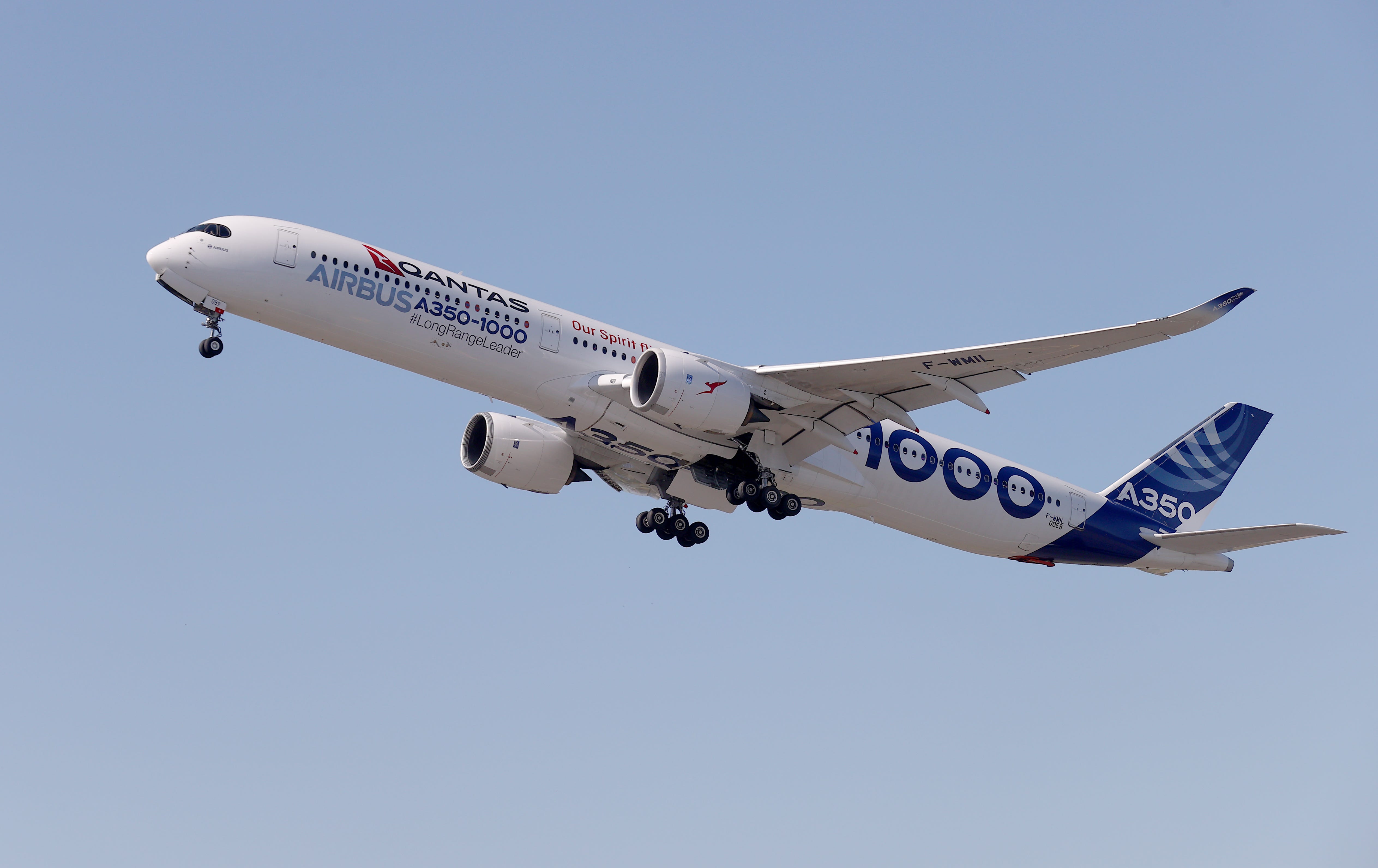 Qantas Airbus A350-1000 flying with a blue sky in background.