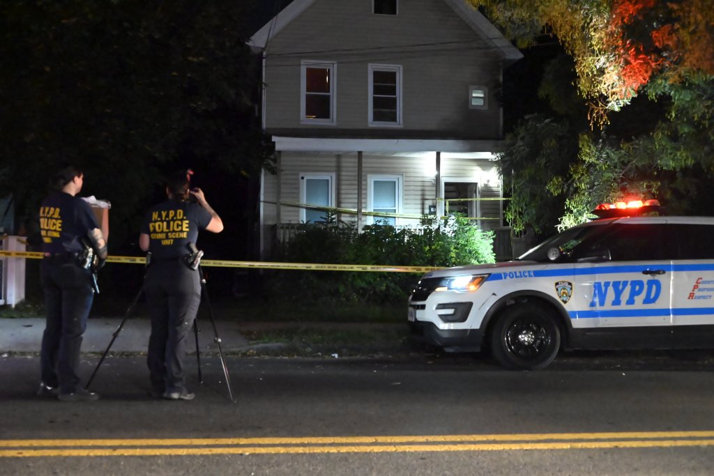 NYPD officers and vehicle at a crime scene on Cary Avenue, Staten Island.