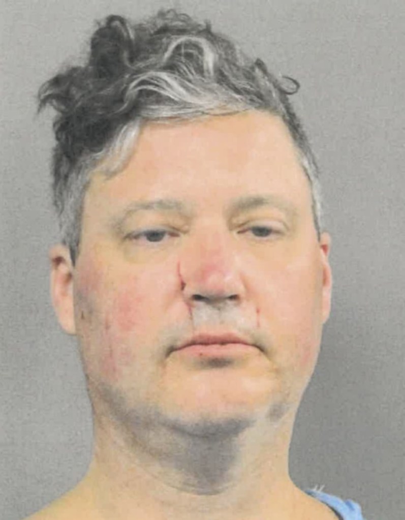 Mugshot of a man with red marks on his face and a visible scar on his nose.
