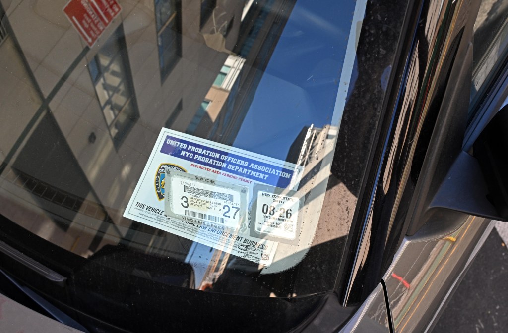 A United Probation Officers Association NYC Probation Department Restricted Area Parking Permit displayed on a car windshield.
