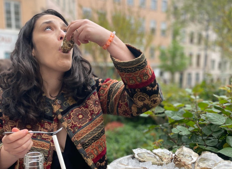 The writer eating an oyster in France.