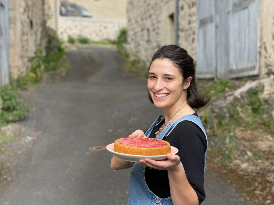 The writer holding up a homemade pie in France.