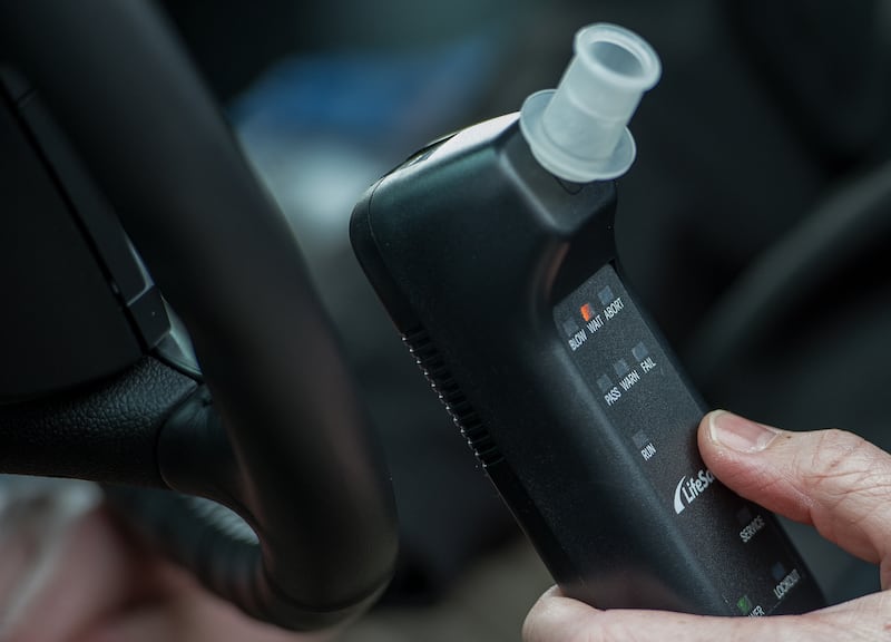 Bill Chastain, State Director with LifeSafer, demonstrates a breath alcohol ignition interlock device during a "Drive Sober or Get Pulled Over" press conference announcing a holiday crack-down on drunk and drugged driving December 17, 2013  in Washington, DC.    AFP PHOTO/Paul J. Richards