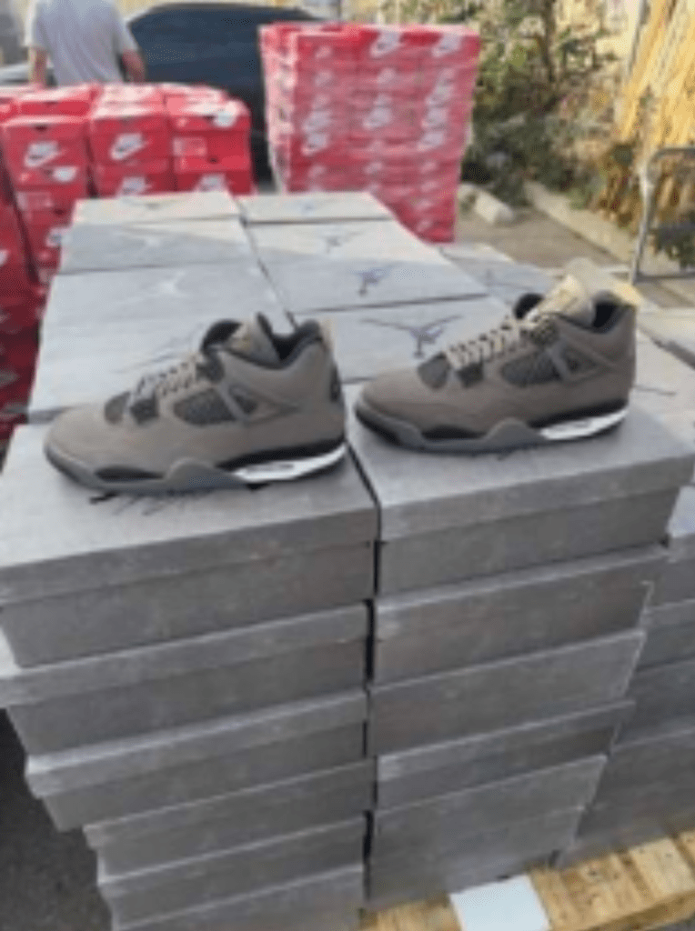A pair of Jordans are displayed on the confiscated boxes outside the warehouse.