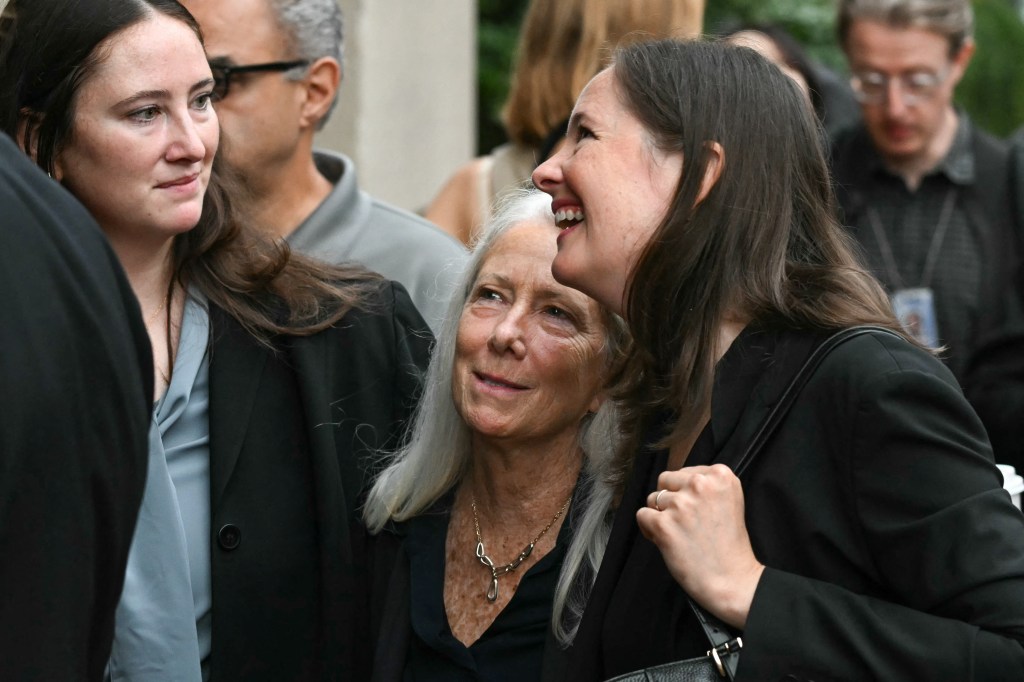 Patrice Failor, wife of James Comey, walks with their daughters Maurene and Claire.