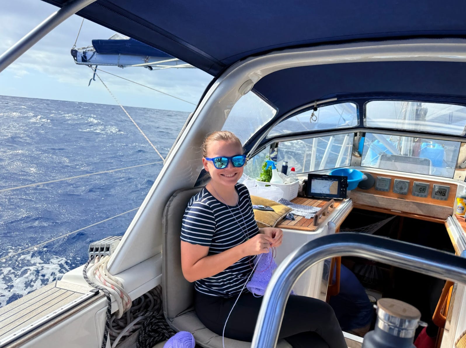 The writer knitting while sailing across the Atlantic.