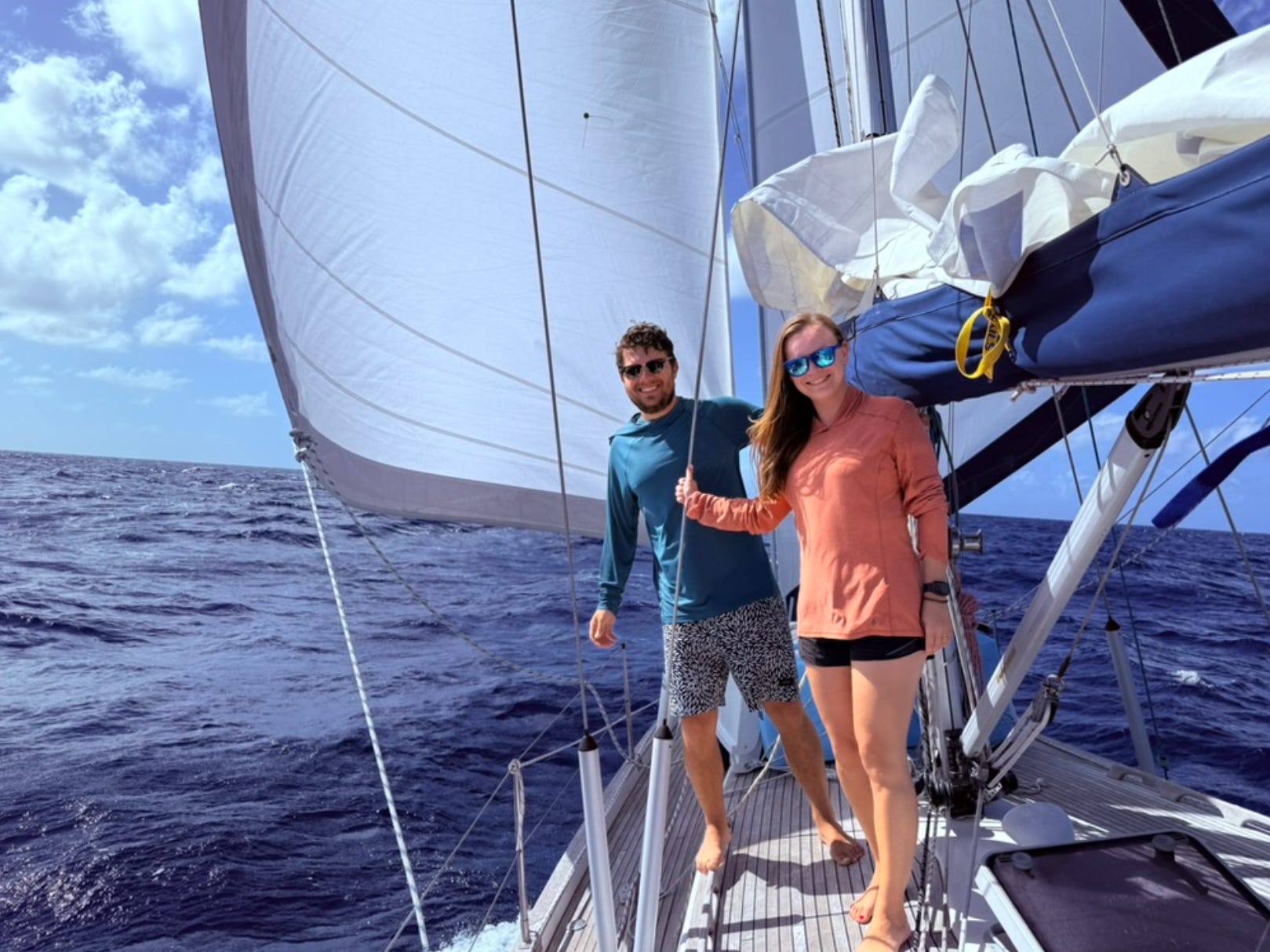 The writer and her husband at sea on a sailboat.