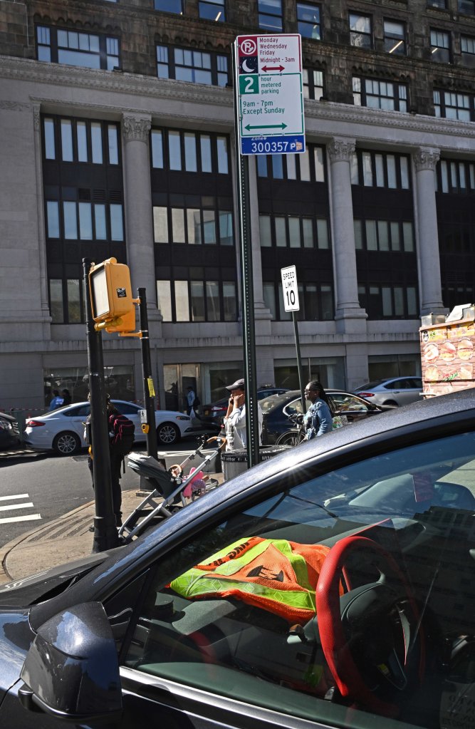 A street scene featuring a parking sign with a 2-hour metered parking rule from 9 AM to 7 PM except Sunday, and restrictions from Midnight to 3 AM on Monday, Wednesday, and Friday.