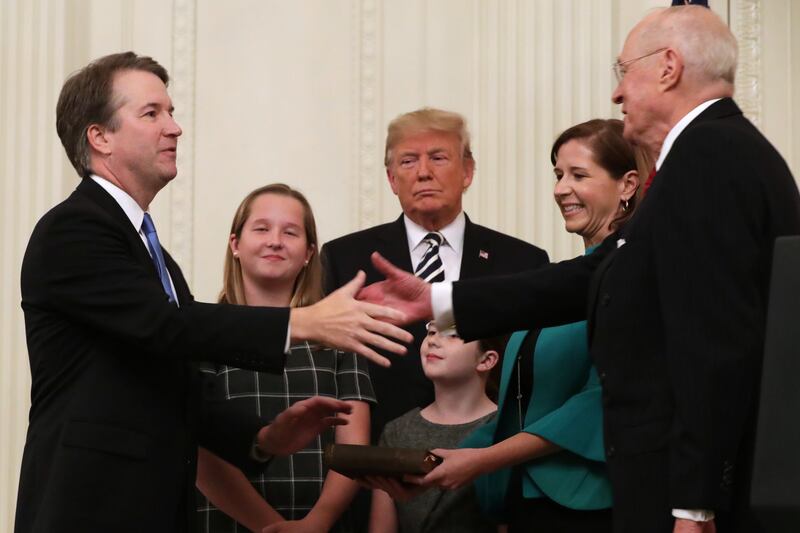Supreme Court Justice Brett Kavanaugh shakes hands with retired Justice Anthony Kennedy after Kavanaugh's ceremonial swearing in with President Donald Trump at the White House October 08, 2018.