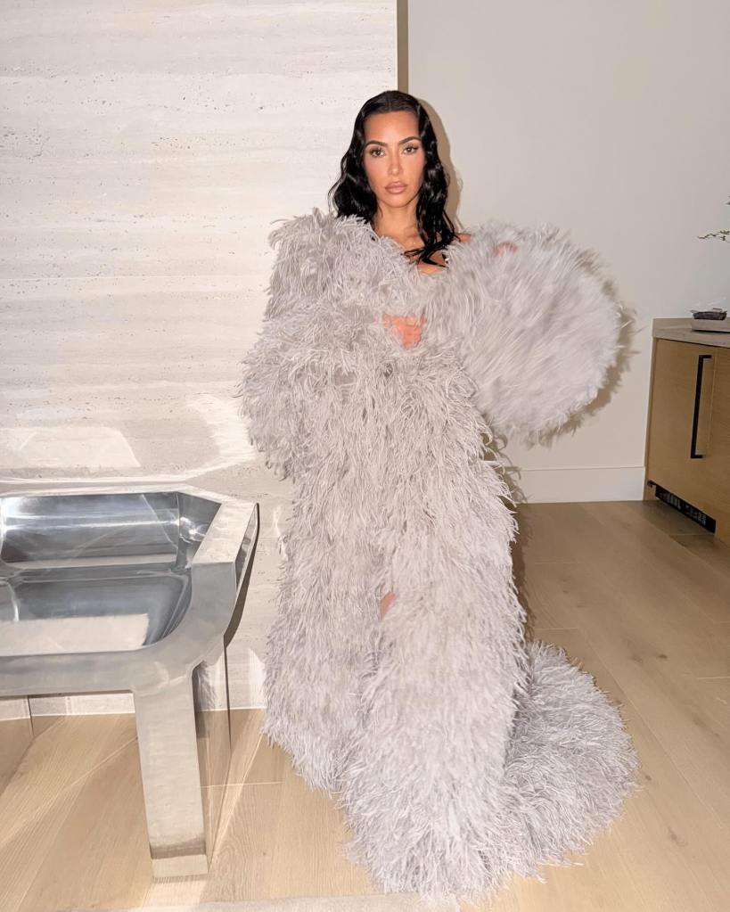 Kim Kardashian in a long gray feathered coat.