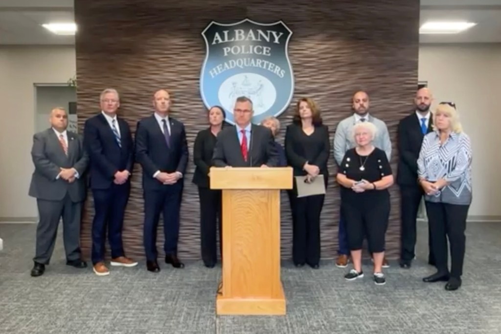 Albany Police Chief Brendan Cox, District Attorney Lee Kindlon, and Catherine Blackburn's family at a press conference.