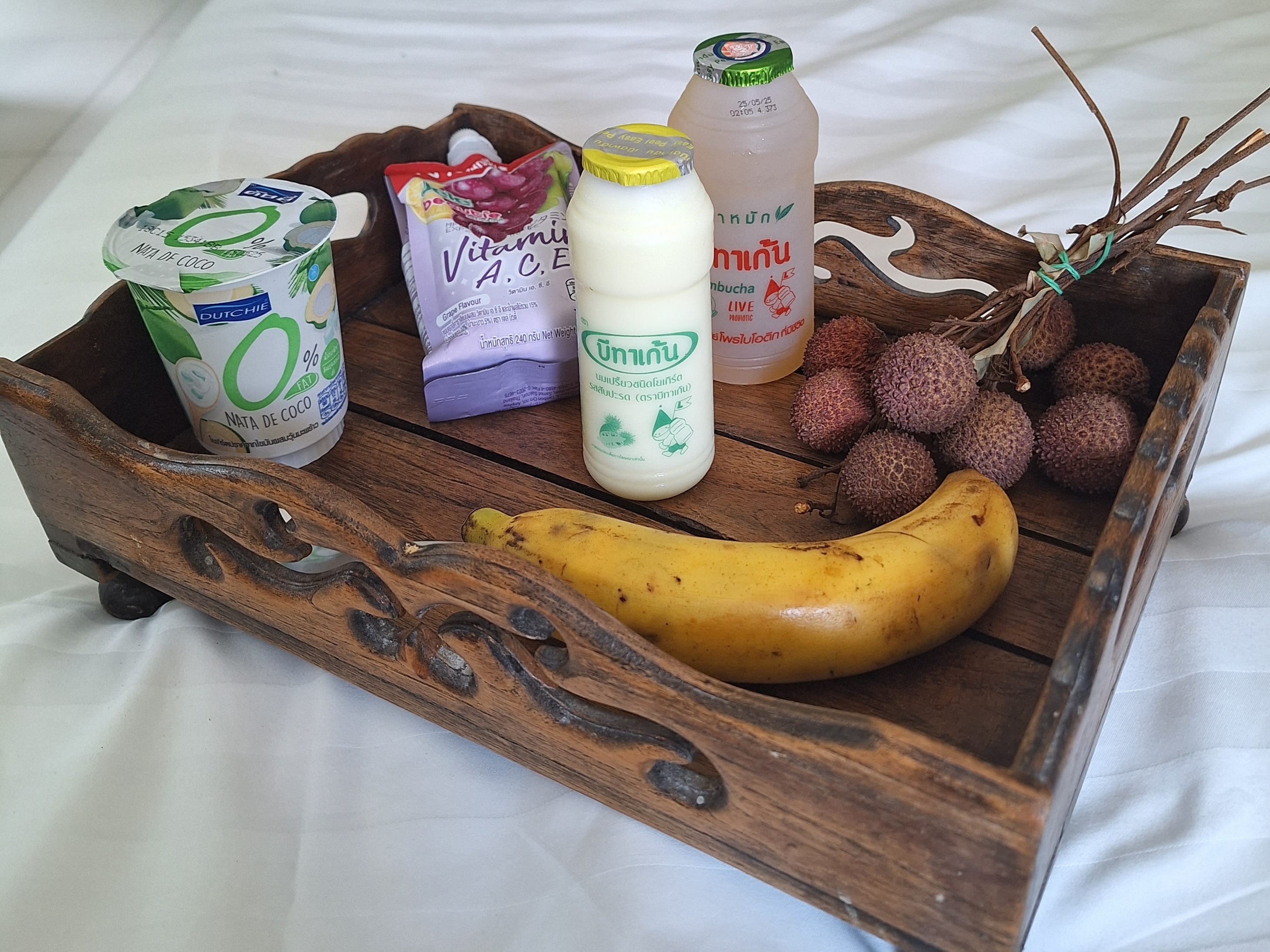 Yogurt, banana, and fruit on a tray in Phuket, Thailand.