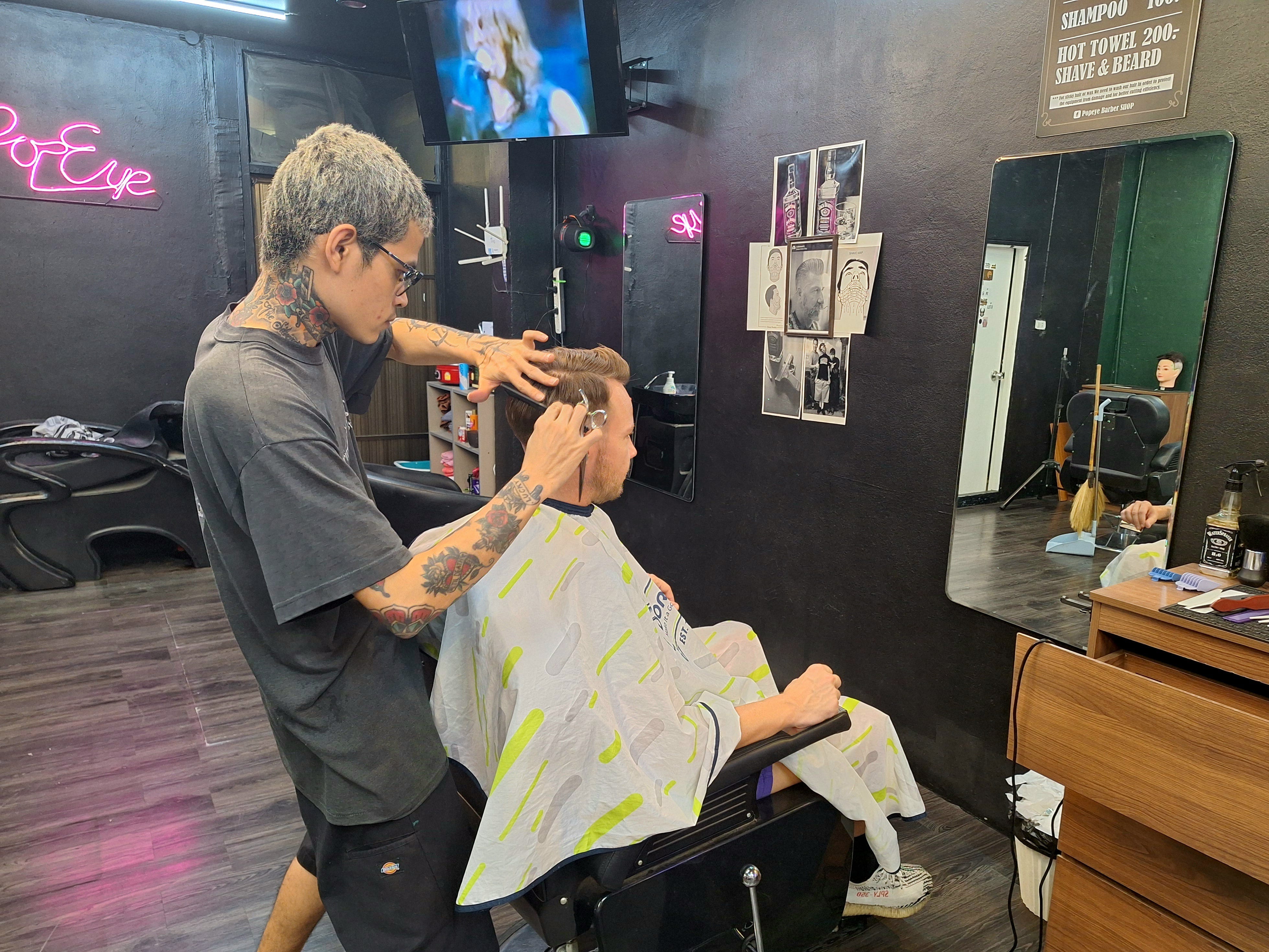 Andre Neveling at the barber getting a haircut in Phuket, Thailand.