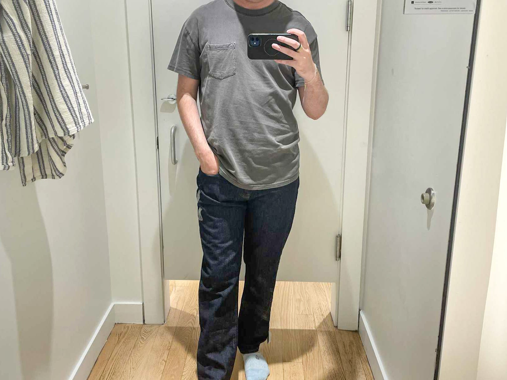 Mike taking a mirror picture inside a Gap fitting room.