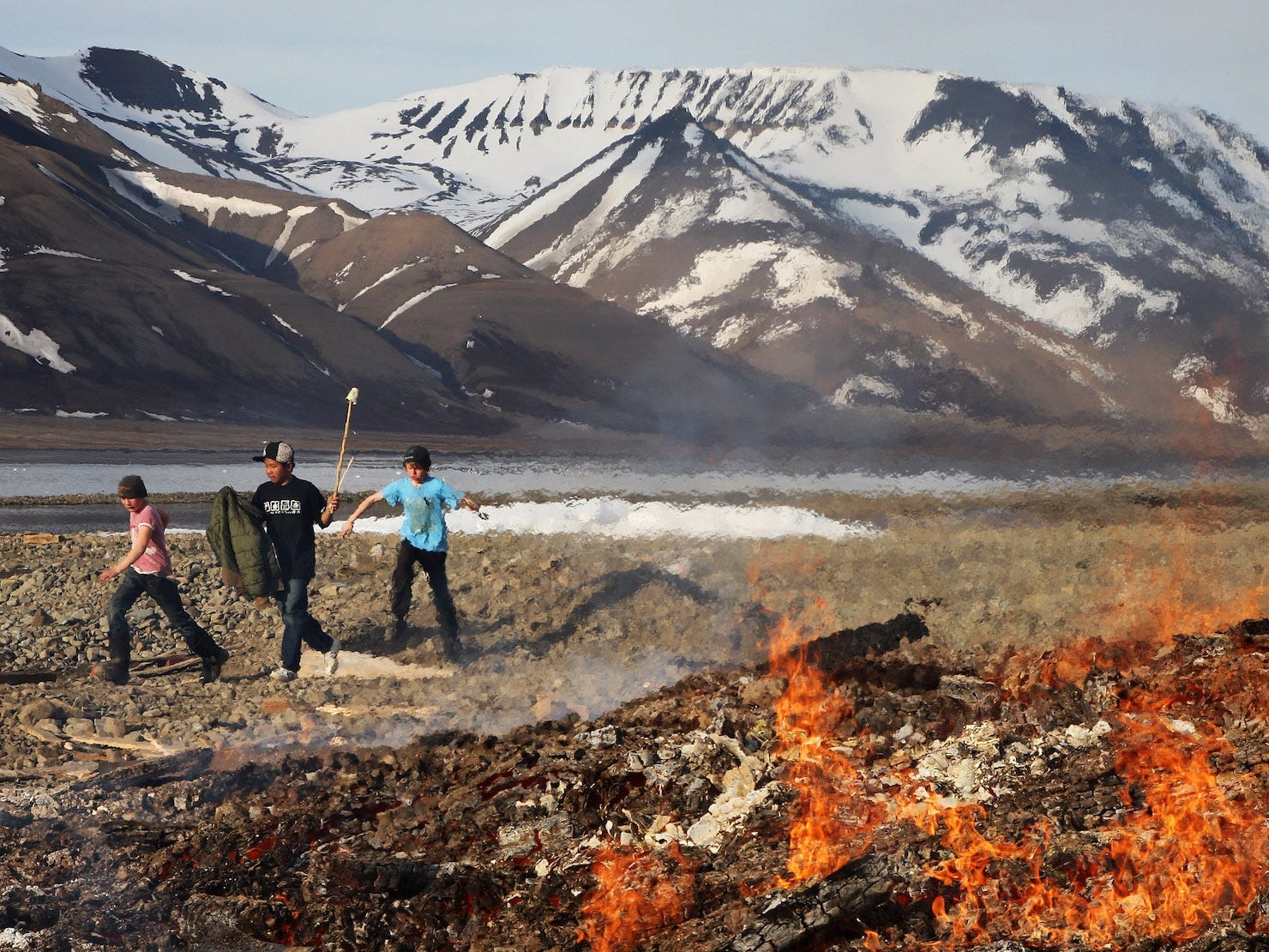 Children hold sticks to protect from Arctic Terns attcking next to a bonfire at the sailing club at a party to celebrate Midsummer on June 21, 2008 in Longyearbyen, Norway. Longyearbyen is the seat of Norwegian local administration in Svalbard, 620 miles south of the North Pole. It was founded in 1906 by the American John Munroe Longyear who started coal mining here, something that has been an important part of the history ever since. Three important mines currently work on Svalbard. Longyearbyen was only opened for general tourism in 1990 and is a haven for eco-tourists who come to see the abundant polar bears, seals and whales. Svalbard consists of a group of islands ranging from 74? to 81? North, and 10? to 35? East, thus making it the northernmost part of Norway. It boasts the world's northernmost Church, Museum and higher education facilities.