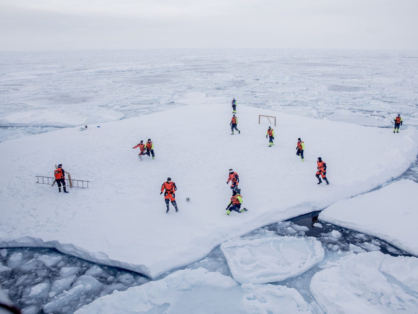 KV Svalbard's crew, formed by Norwegian Navy privates and scientists from Norwegian Institute of Marine Research, play soccer as they are protected from polar bears by armed guards in the arctic environment in the sea around Greenland, March 22, 2018. Picture taken March 22, 2018.