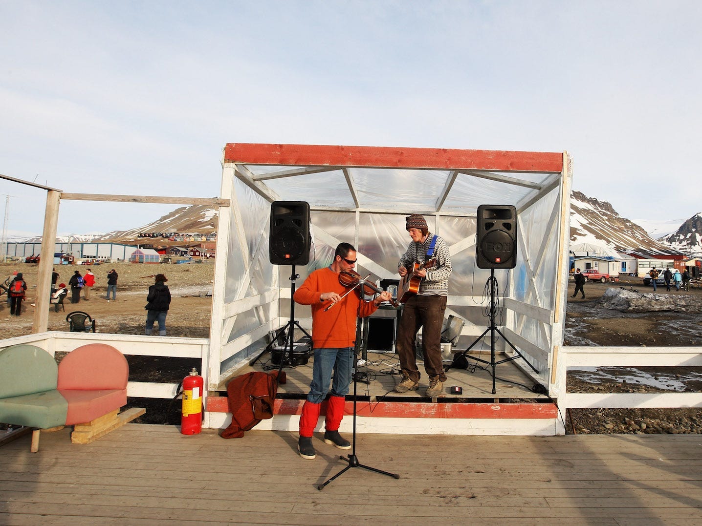 : Two men play instruments at the sailing club party to celebrate Midsummer on June 21, 2008 in Longyearbyen, Norway. Longyearbyen is the seat of Norwegian local administration in Svalbard, 620 miles south of the North Pole, and was founded in 1906 by the American John Munroe Longyear who started coal mining here, an important part of the local history ever since. Longyearbyen was only opened for general tourism in 1990 and is a haven for eco-tourists who come to see the abundant polar bears, seals and whales. Svalbard consists of a group of islands ranging from 74? to 81? North, and 10? to 35? East, thus making it the northernmost part of Norway. (Photo by Chris Jackson/Getty Images)