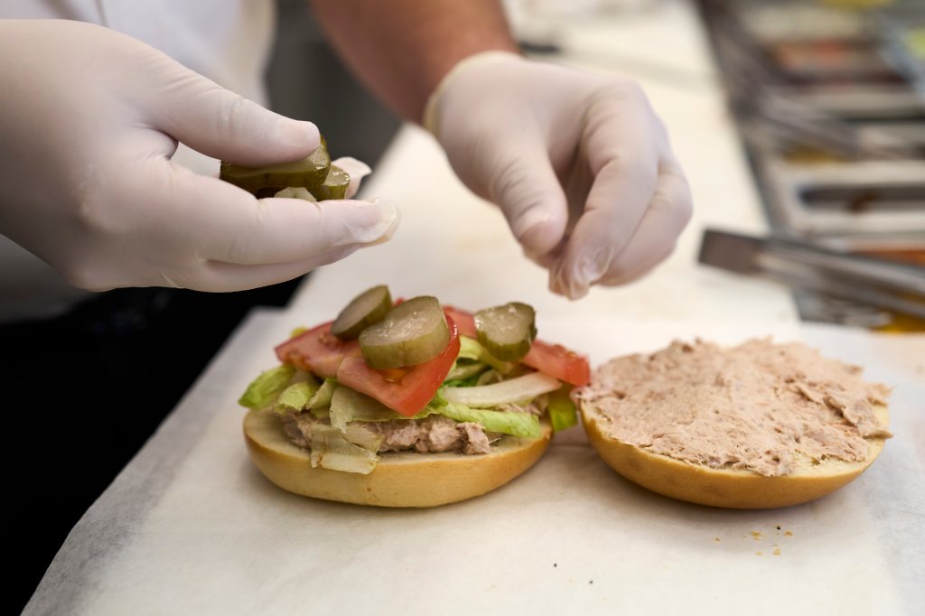 Zoom owner Moshe Green prepares a tuna salad sandwich.