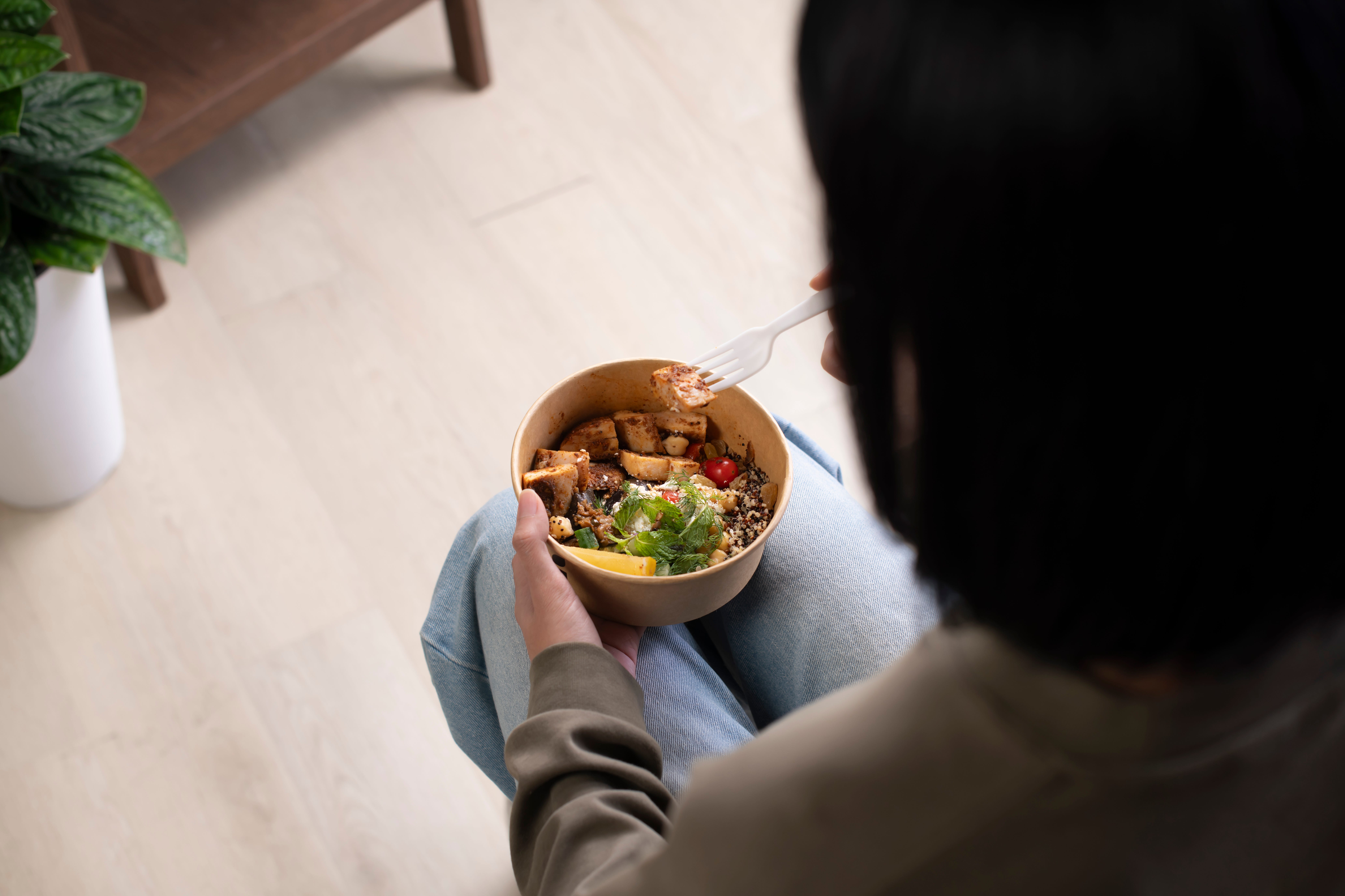 A woman eating while sitting