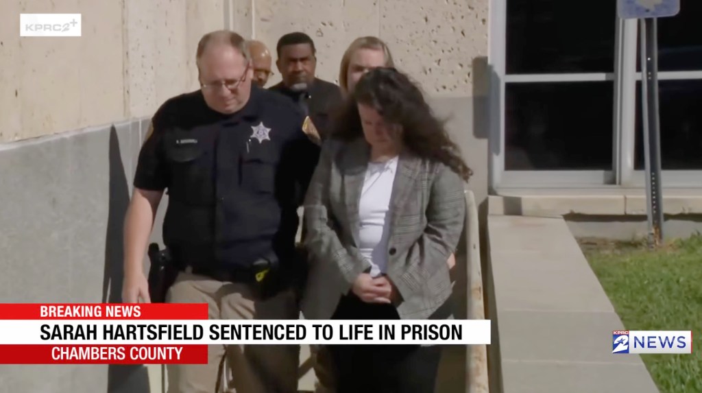 Sarah Hartsfield, a 50-year-old former US Army sergeant, is escorted from court by law enforcement after being sentenced to life in prison.