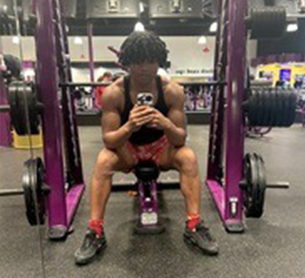 Kelvin Luebke sitting in a gym.
