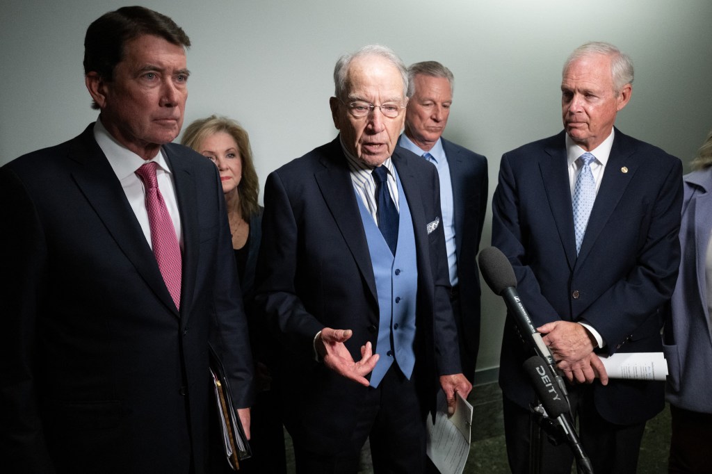 Senator Chuck Grassley, surrounded by Senators Bill Hagerty, Marsha Blackburn, Tommy Tuberville, and Ron Johnson, speaks at a press conference.