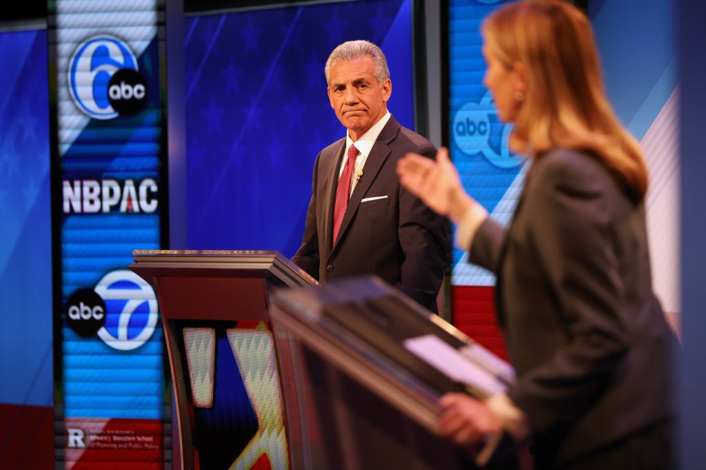 Republican Jack Ciattarelli, left, looks on while Democrat Mikie Sherrill speaks during the final debate in the New Jersey governor's race, Wednesday, Oct. 8, 2025, in New Brunswick, NJ.