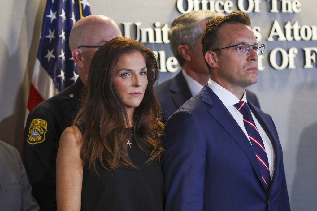 Conservative host Benny Johnson and his wife Katelyn Johnson at a news conference.