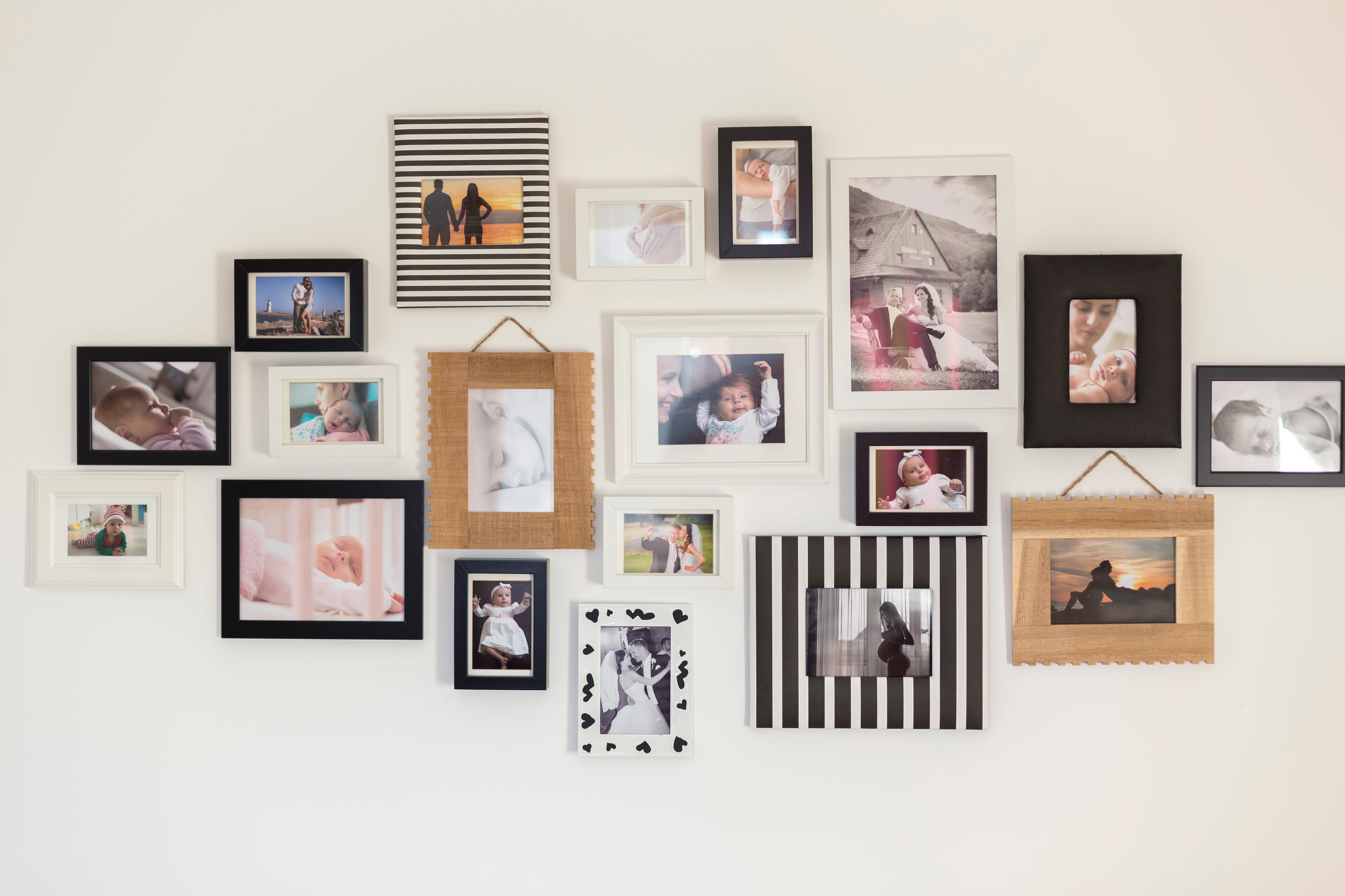 A wall of several family photos in frames.
