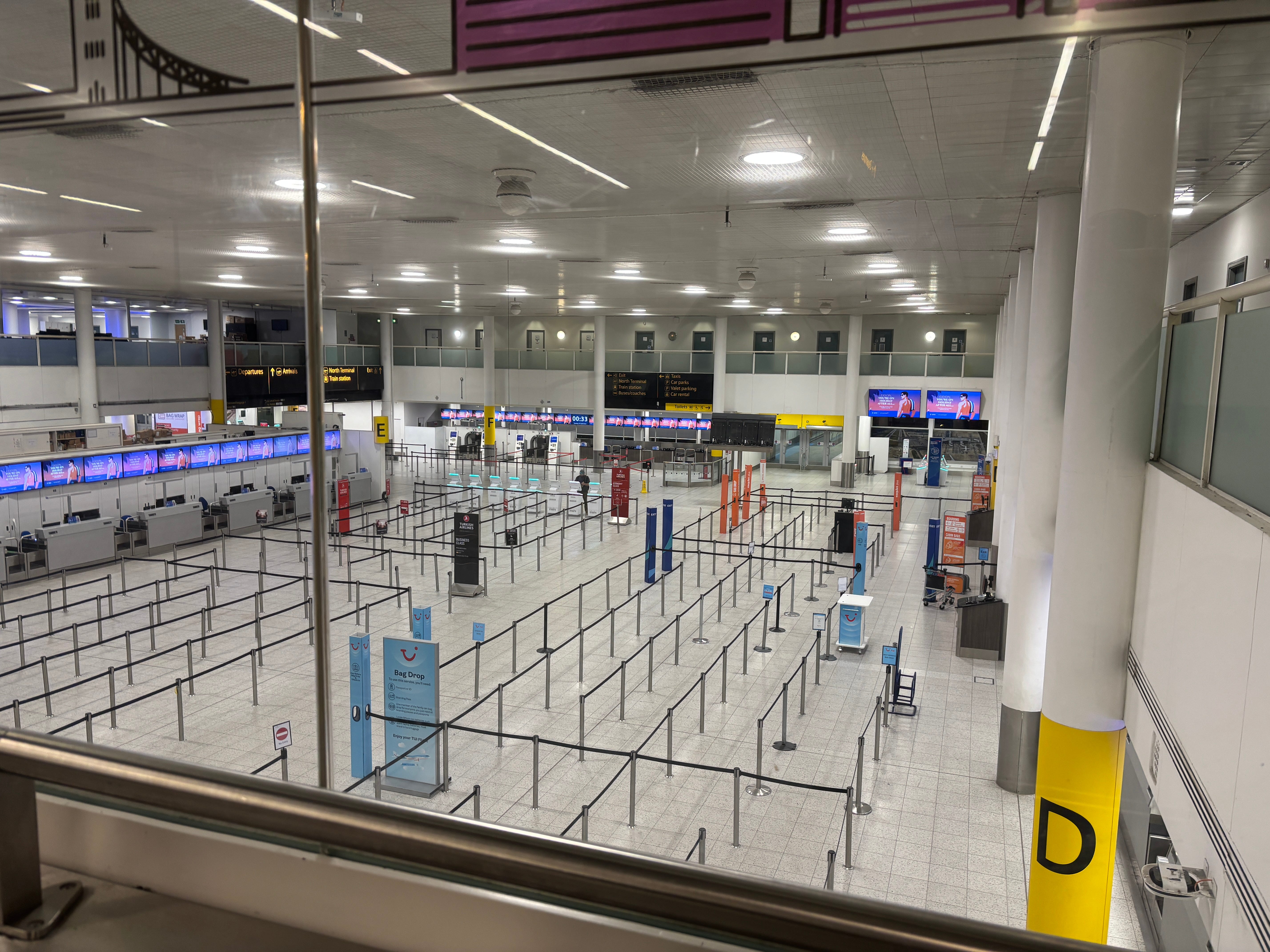 An empty check-in zone at London Gatwick Airport at night early on Tuesday 25 September, 2025