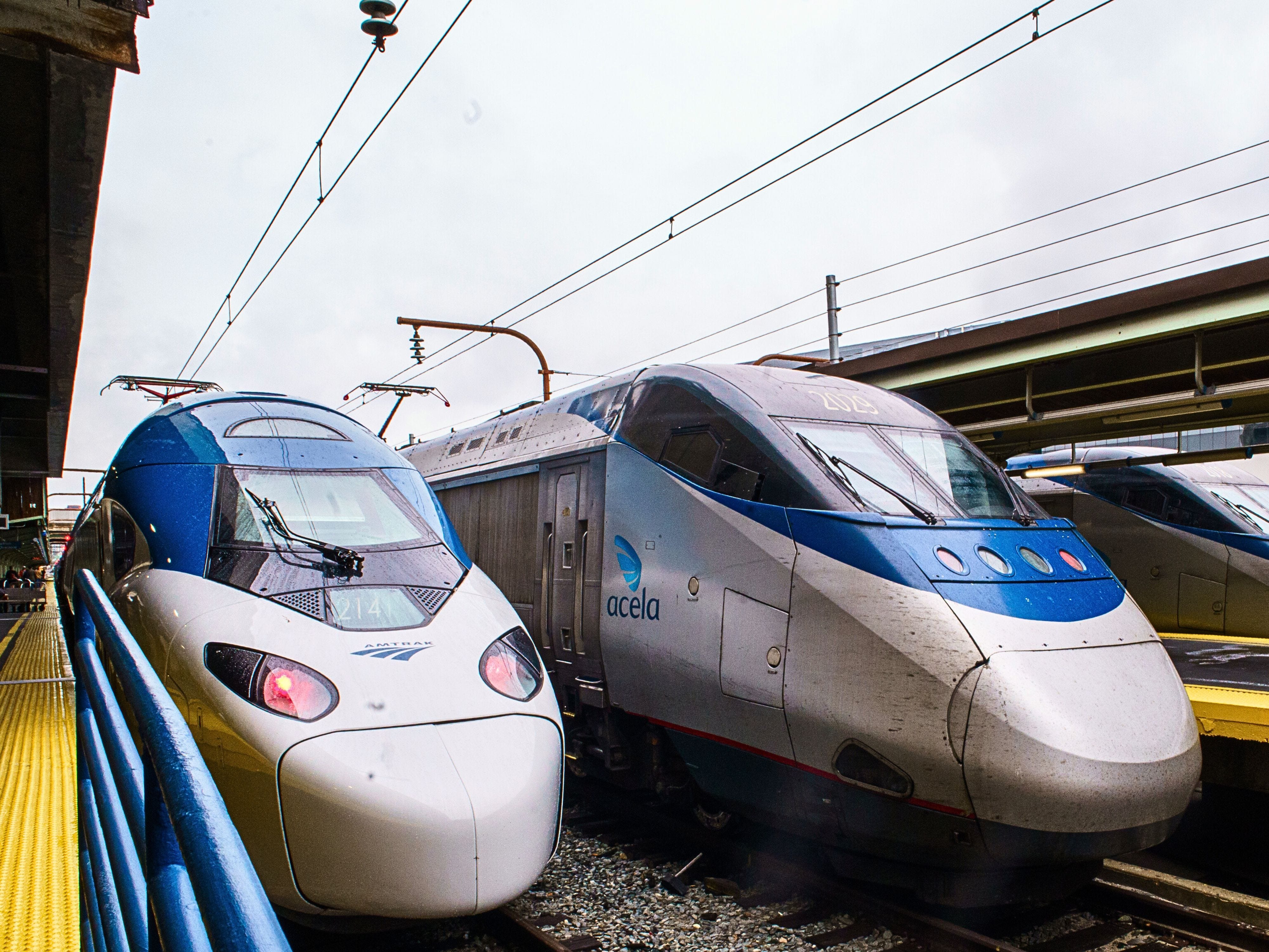 An Amtrak NextGen Acela parked next to the older Acela model