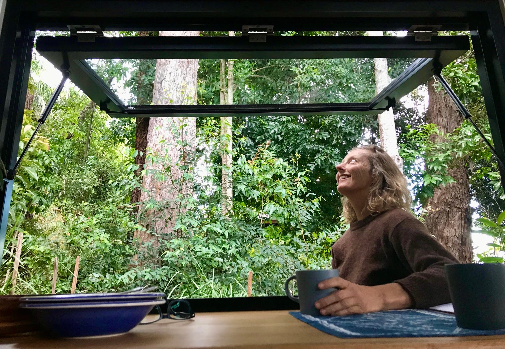 Louise Southerden sitting outside her tiny house