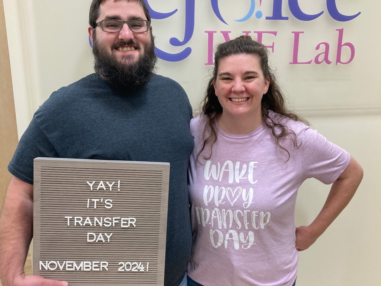 A couple holding a sign that says